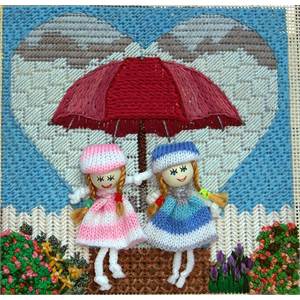 Photograph of stitched canvas with knit doll embellishments.